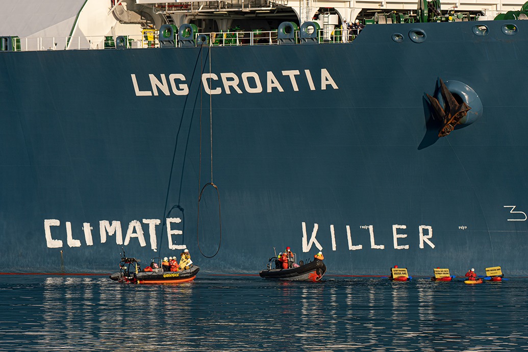 Greenpeace activists write a message on Croatian FSRU